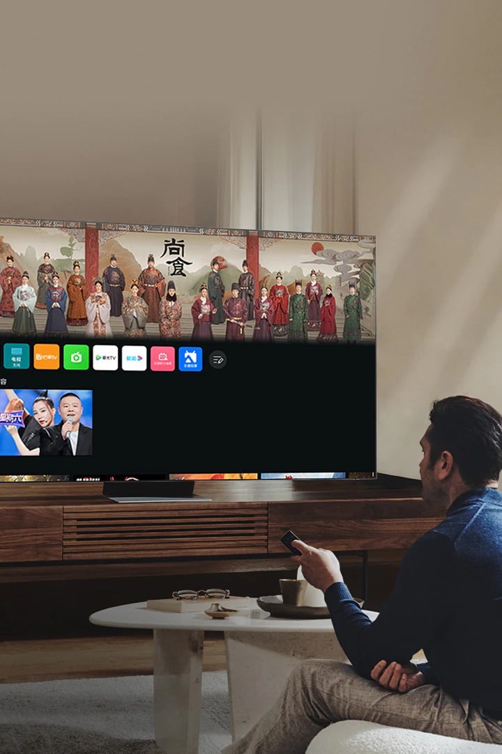A man is in his living room viewing the new Smart Hub UI on his Neo QLED.